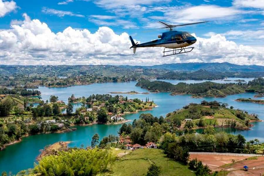 Medellín: Guatapé Private Tour with Helicopter & Boat Ride - Climbing Piedra del Peñol