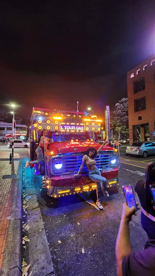 Medellin: Party Bus with DJ & Street Food Tastings - The night begins in El Poblado