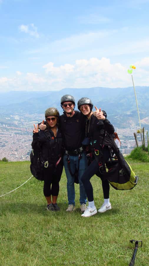 Paraglide over beautiful Medellin - Farmer clothing and grinding coffee by hand